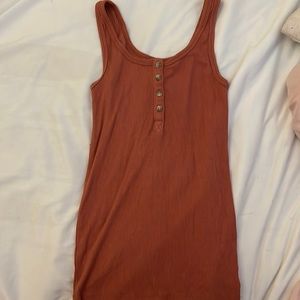 long tank top, can tuck into pants, orange red colour